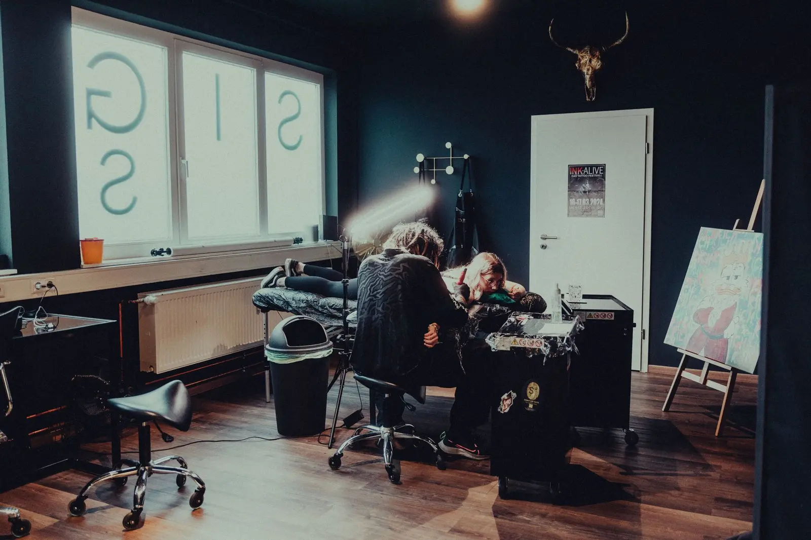 Tattoo artist at work in a modern tattoo studio